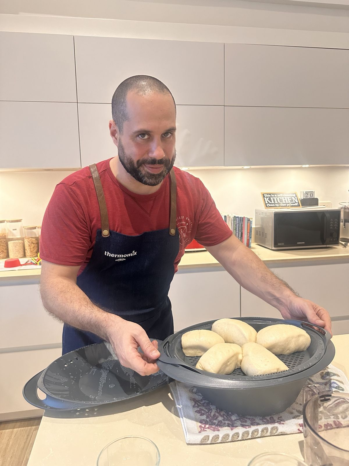 Chef Moreno Benigno with steamed buns in a cooking class with Thermomix