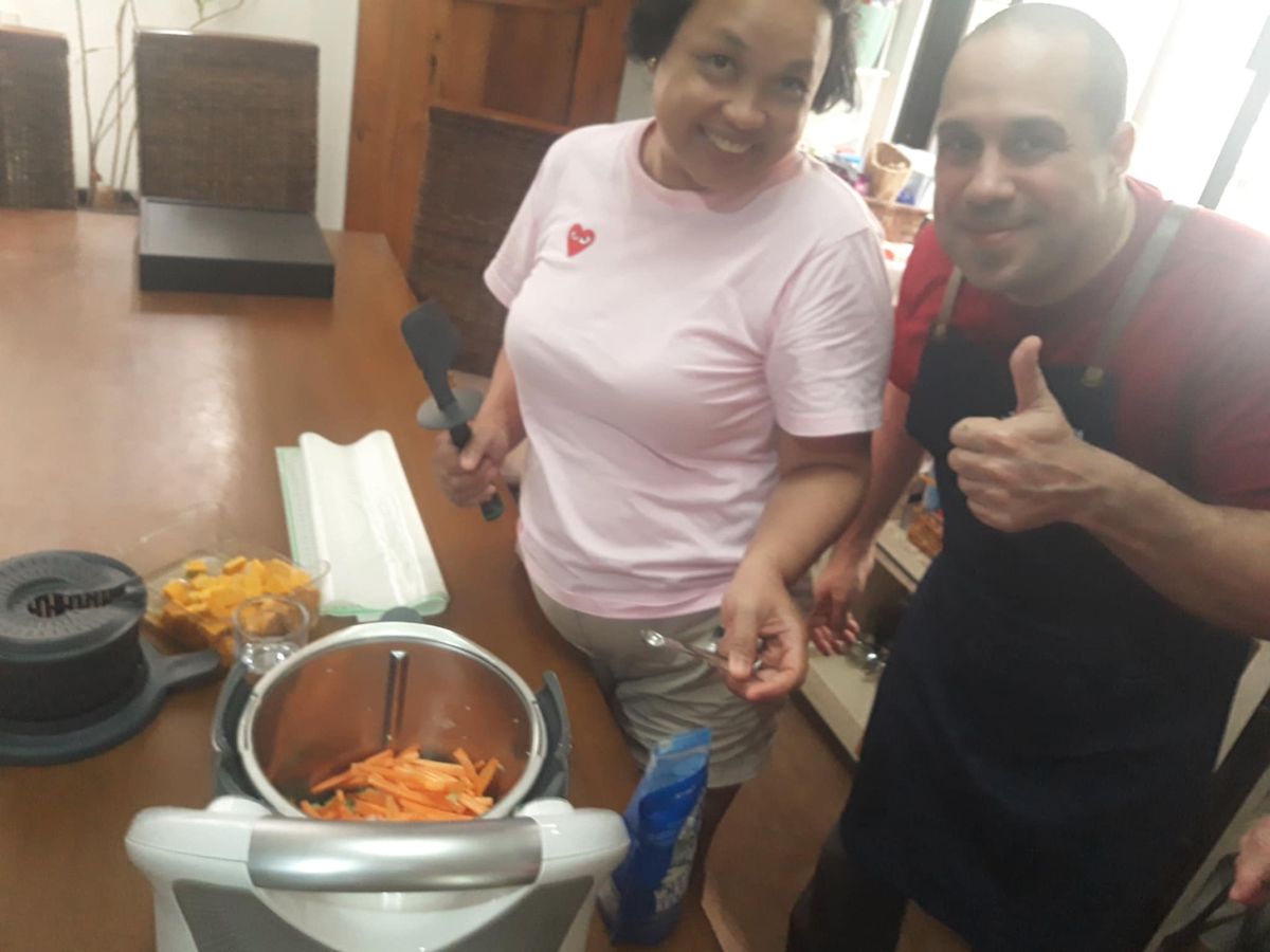 Chef Moreno Benigno cooking with a student
