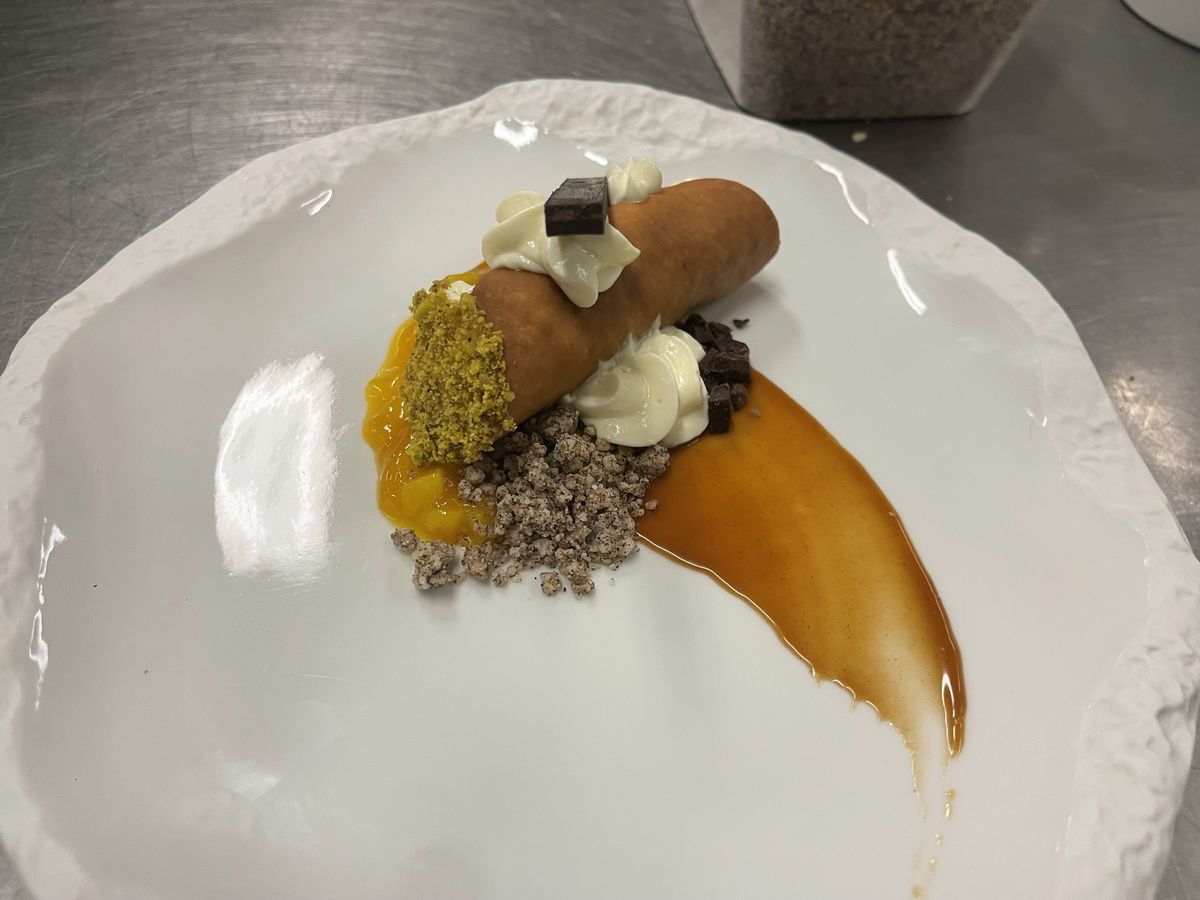 Plated cannoli dessert with pistachio, mango and chocolate, by Chef Moreno Benigno