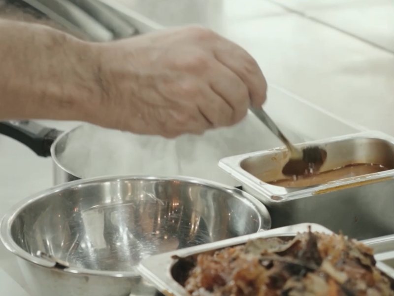 Chef Moreno finishing a sauce on the line