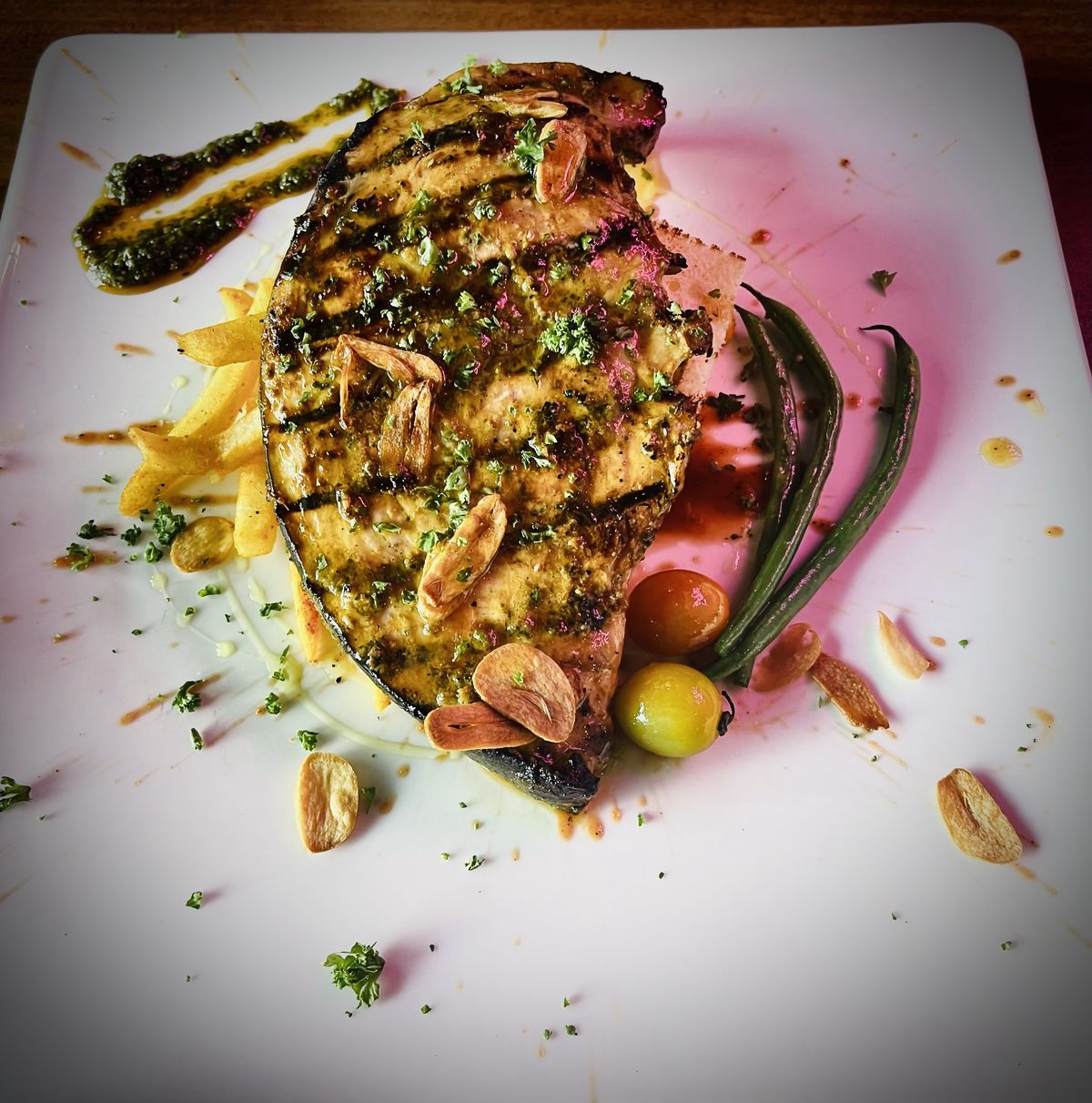 Grilled swordfish steak with garlic chips and herb sauce, by Chef Moreno Benigno
