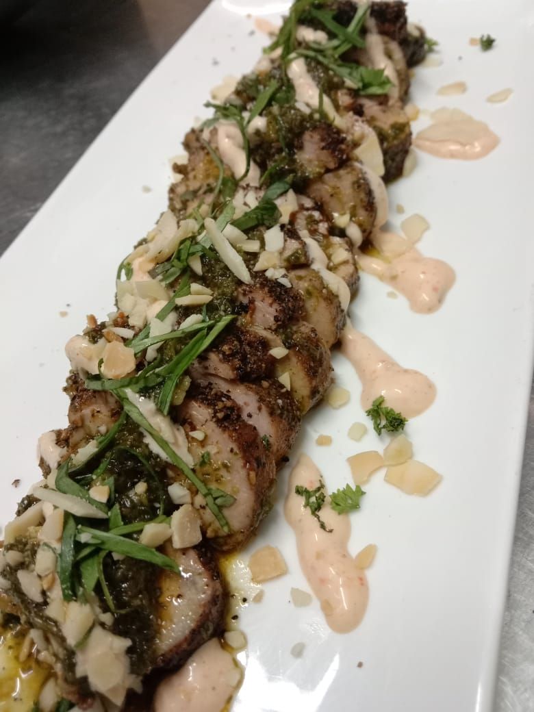 Sliced grilled beef tenderloin with chimichurri and almonds, by Chef Moreno Benigno