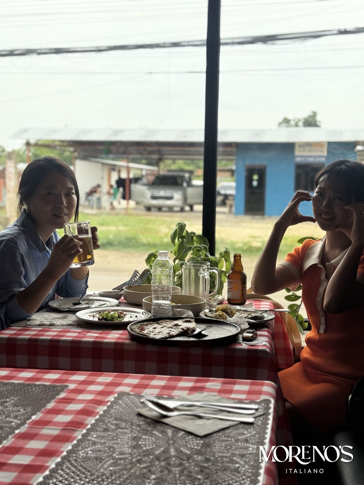 Friends dining by the window at Moreno's Italiano