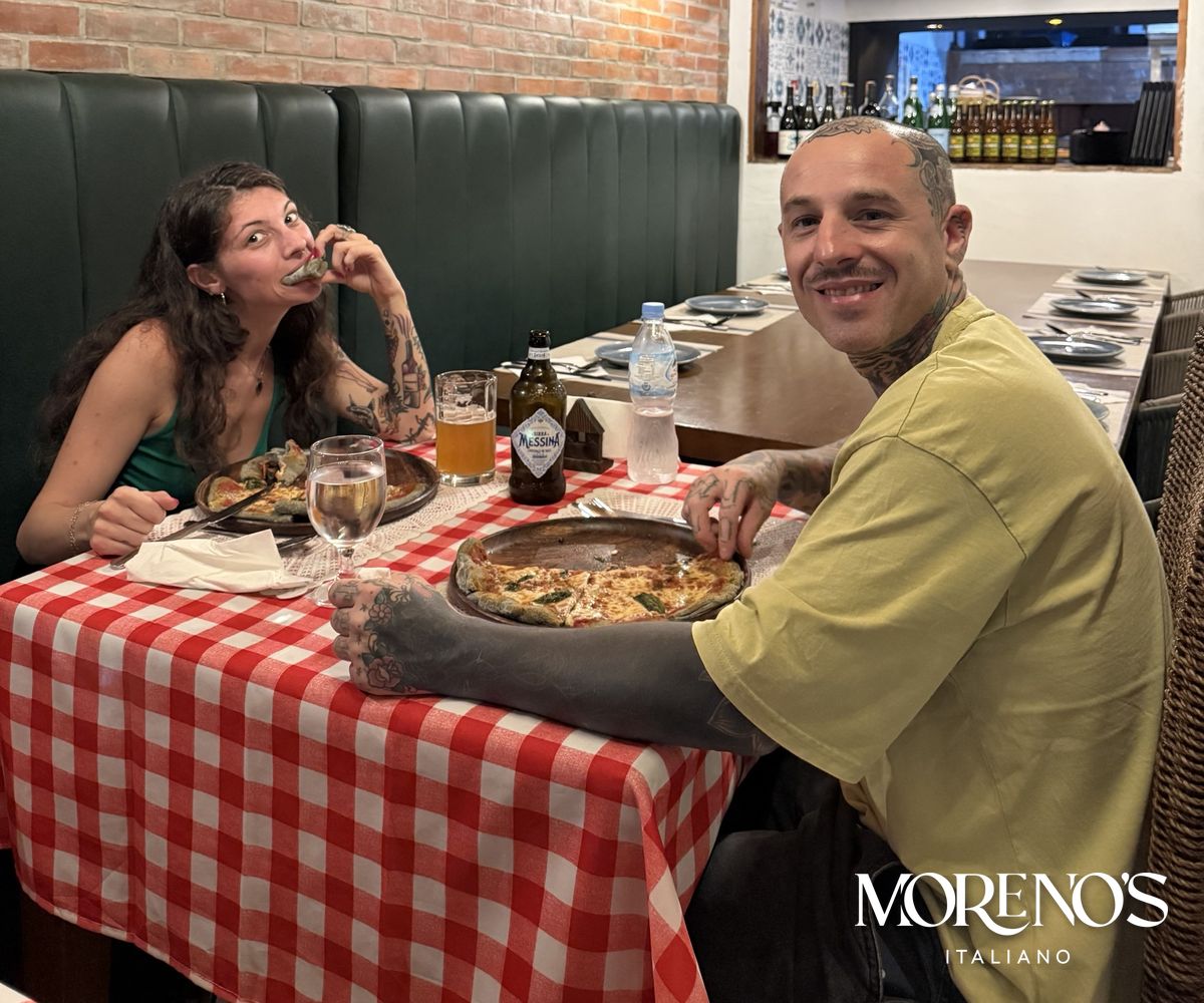 Guests sharing pizza at Moreno's Italiano